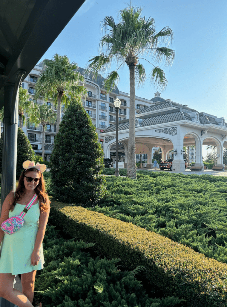 Woman standing in front of a Disney resort. 